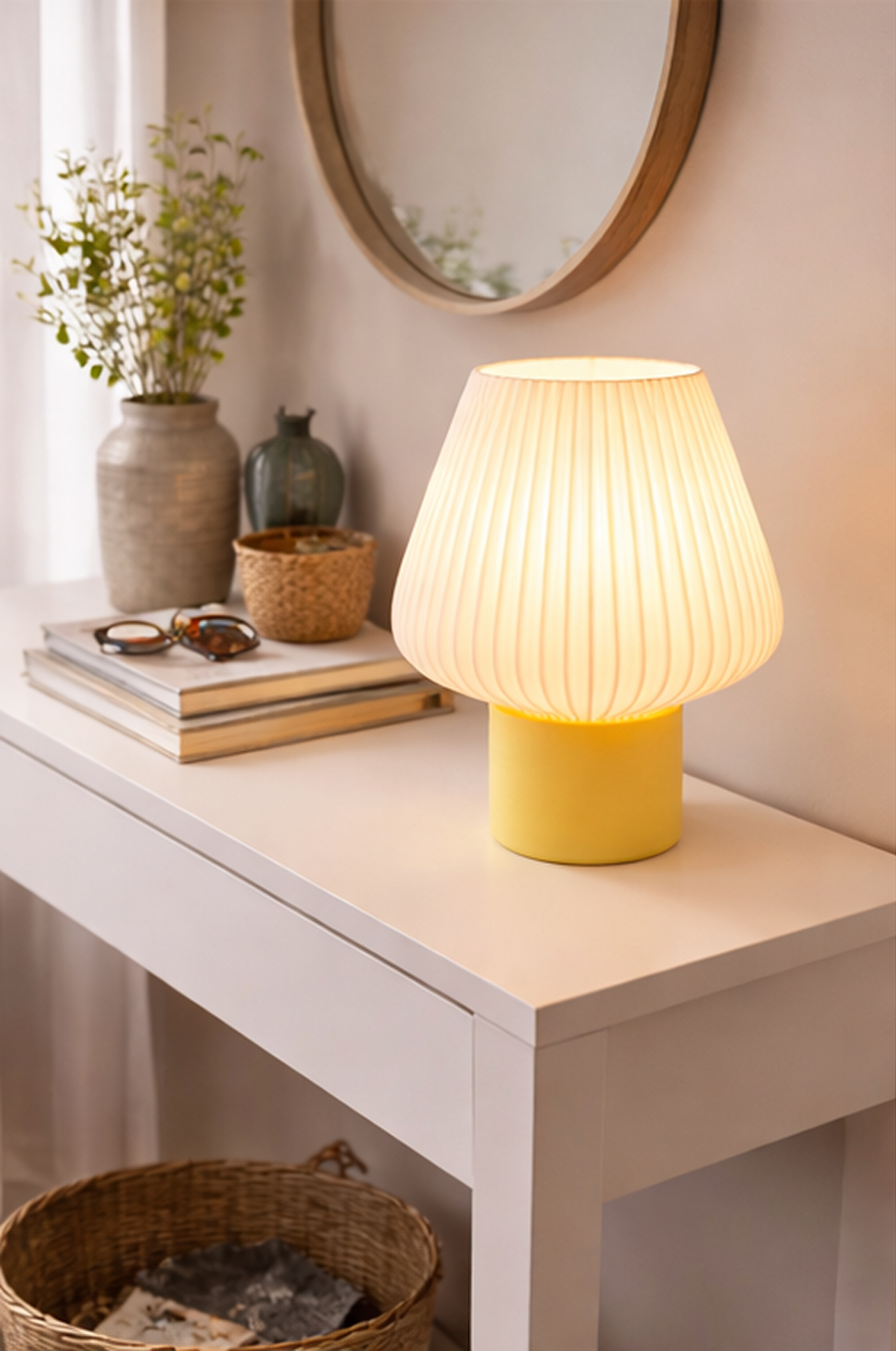 Yellow table lamp on a white surface with decor items in the background